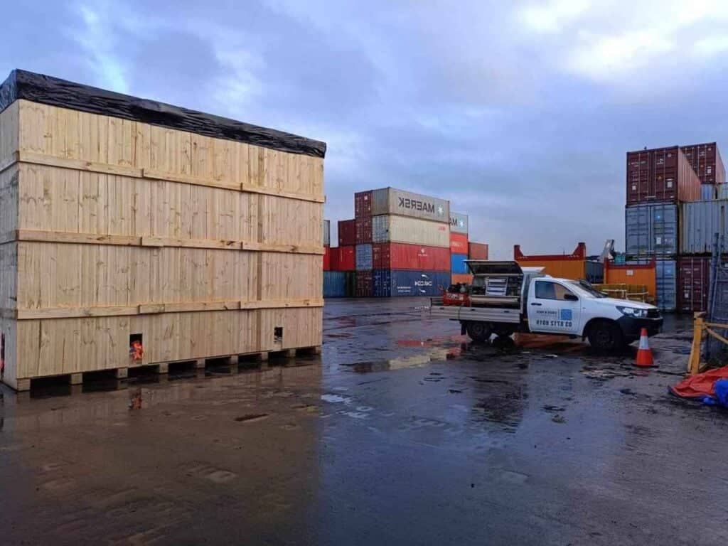 large wood shipping case with crate n pack solutions branded ute and shipping containers in background (24)